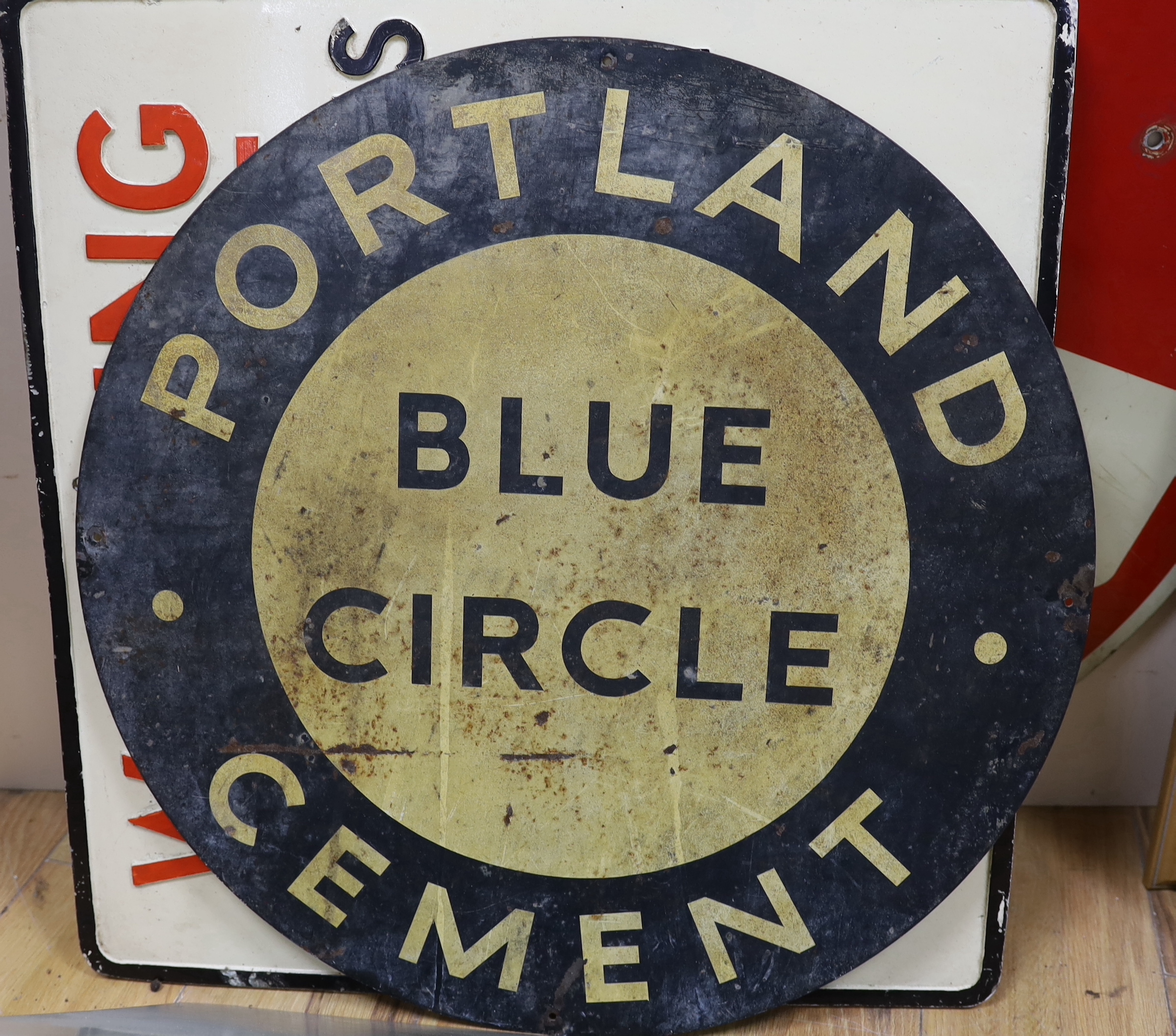 A group of enamel and other signs, including warning signs and cement advertising signs